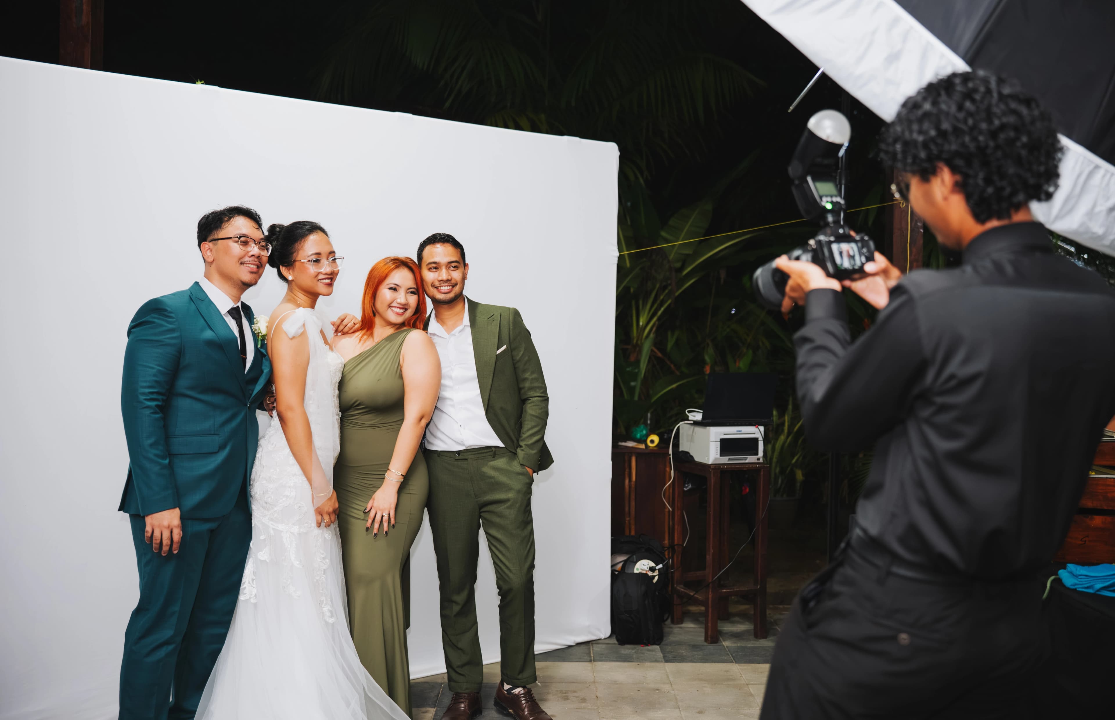On-site event portrait studio setup with a white backdrop and professional lighting.